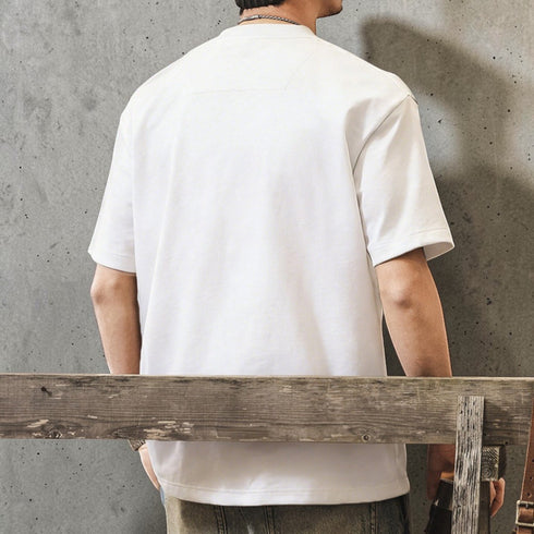 PEAK BLUE white graphic tee with embossed native motif on back, crew neck, short sleeves, relaxed fit.